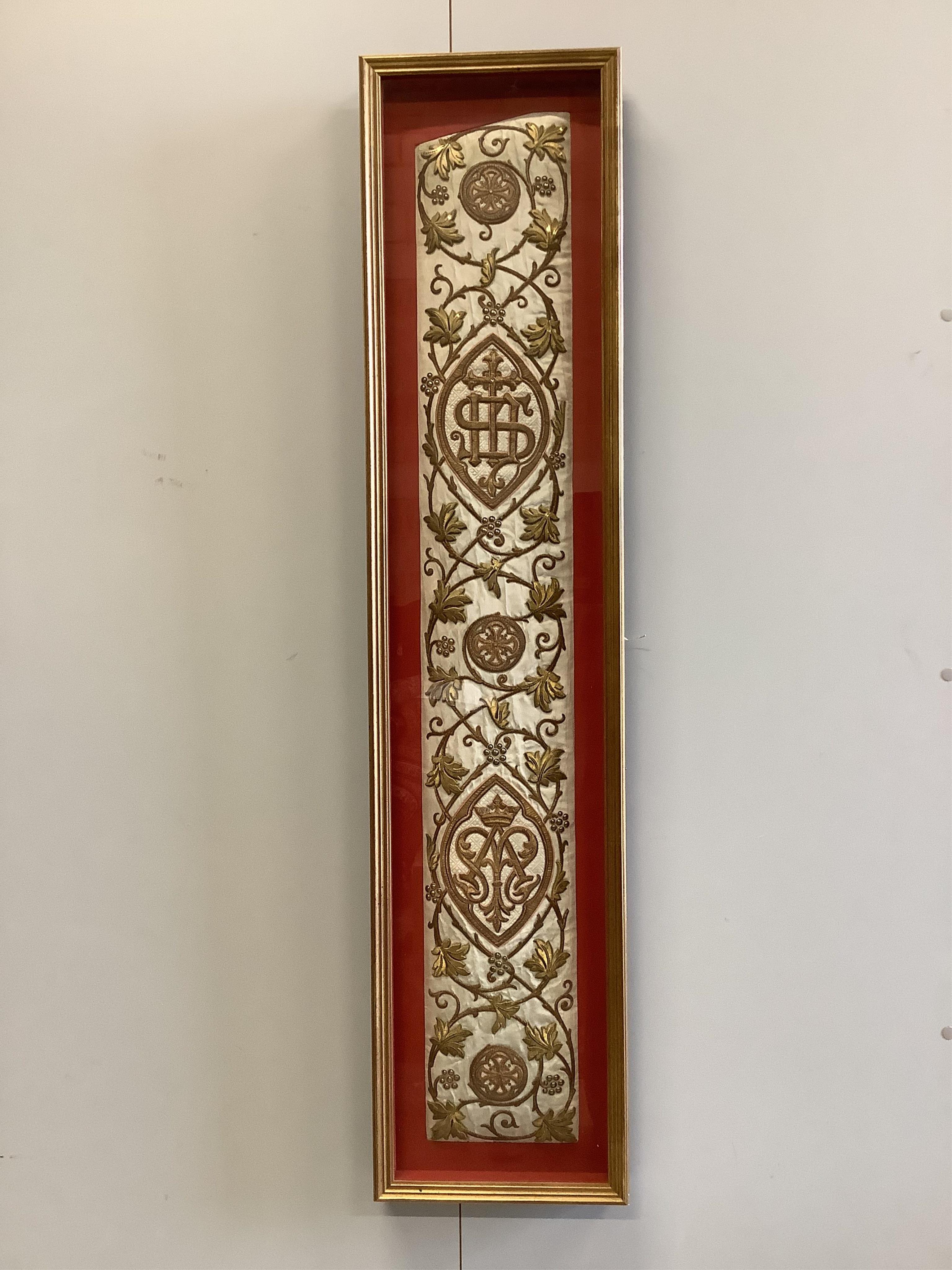 A framed Continental late 18th / 19th century heavily embroidered and deeply couched gold thread and white silk Orphrey panel, possibly part of a Chasuble or similar ecclesiastical garment, 18cm wide x 124cm long. Condit